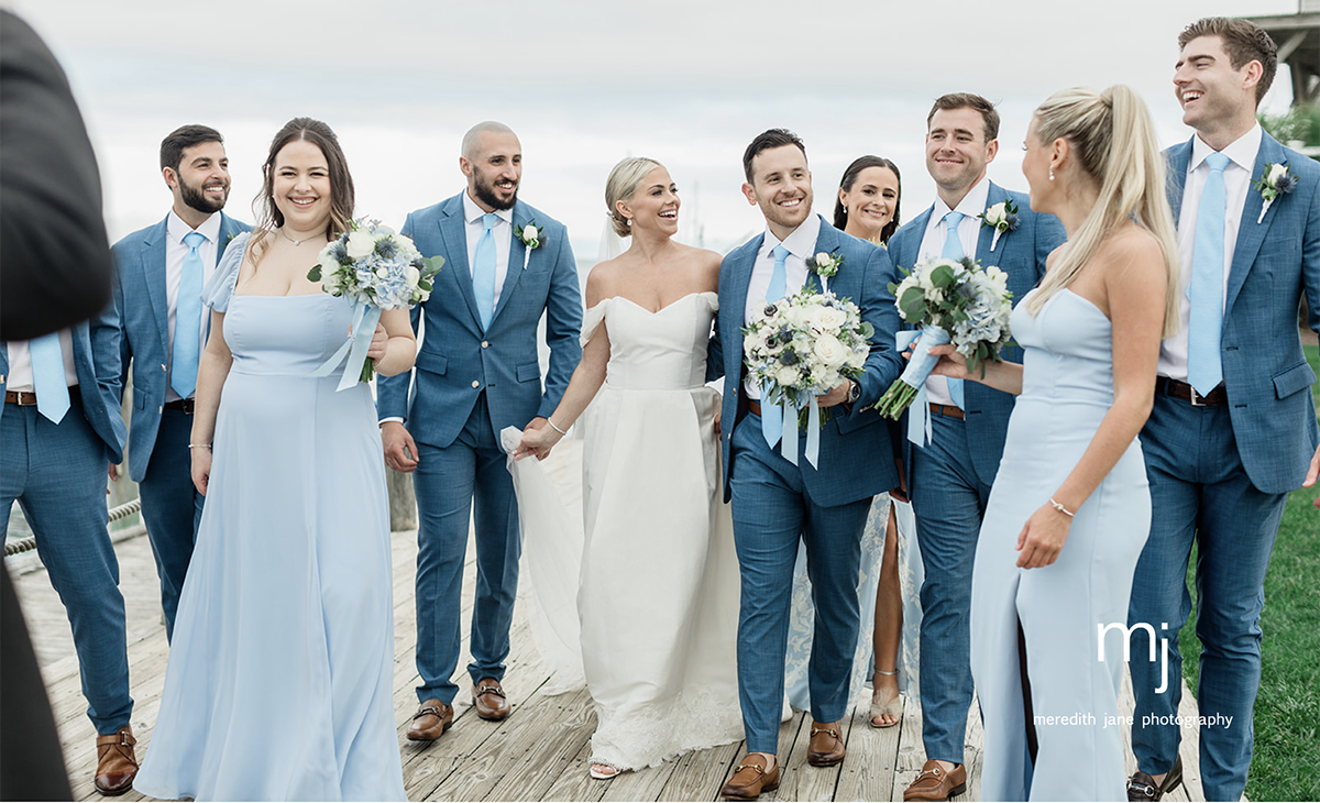 Bride and groom walking with their bridal party.